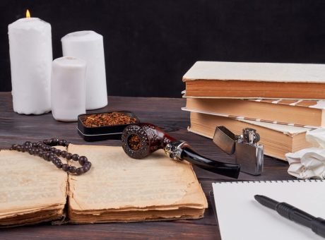 Still life composition books with pipe and candles. Still life composition books with pipe and candles. Vintage writers stuff on wooden table.